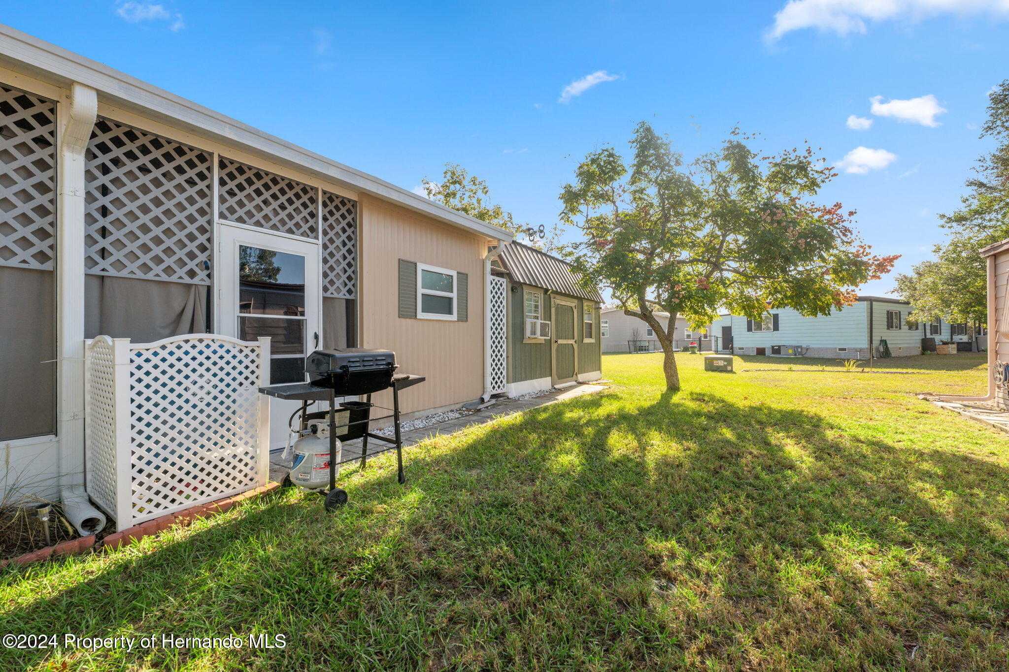 15116 Rialto Avenue Brooksville, FL 34613 - Photo 33 of 36 a view of a house with backyard and sitting area