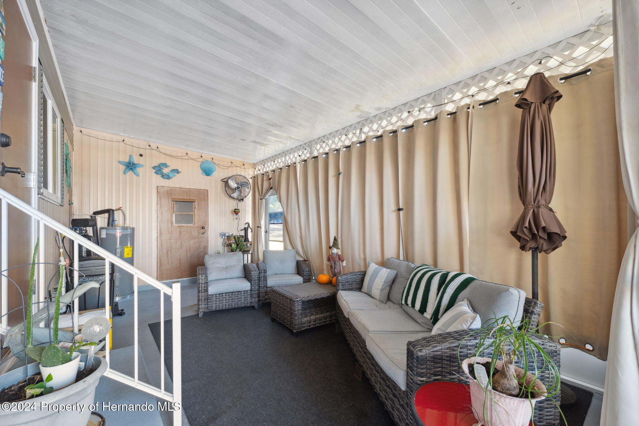 15116 Rialto Avenue Brooksville, FL 34613 - Photo 9 of 36 a living room with furniture and a potted plant