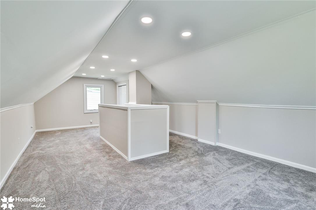 415 Willow Road Hellertown, PA 18055 - Photo 20 of 25 A well-lit attic space offers versatile possibilities with soft carpeting and clean finishes.