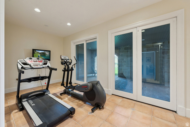 1714 Ridge Point Drive Bountiful, UT 84010 - Photo 84 of 132 Recessed lighting illuminates a versatile space with neutral wall tones and tile flooring