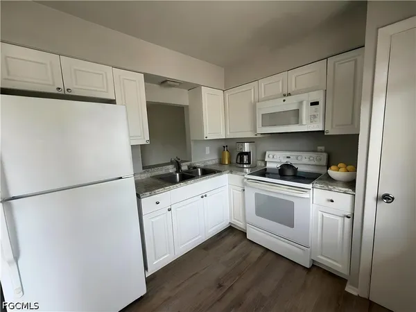 a white refrigerator freezer sitting inside of a kitchen