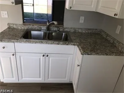 a kitchen with a sink and cabinets