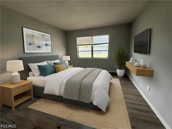 a bedroom with bed and a flat screen tv