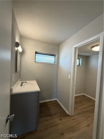 a bathroom with a sink mirror and vanity