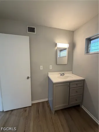 a view of a room with wooden floor and window