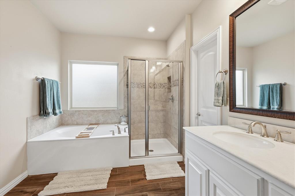 215 Equestrian Road Hickory Creek, TX 75065 - Photo 27 of 36 a bathroom with a tub sink and mirror