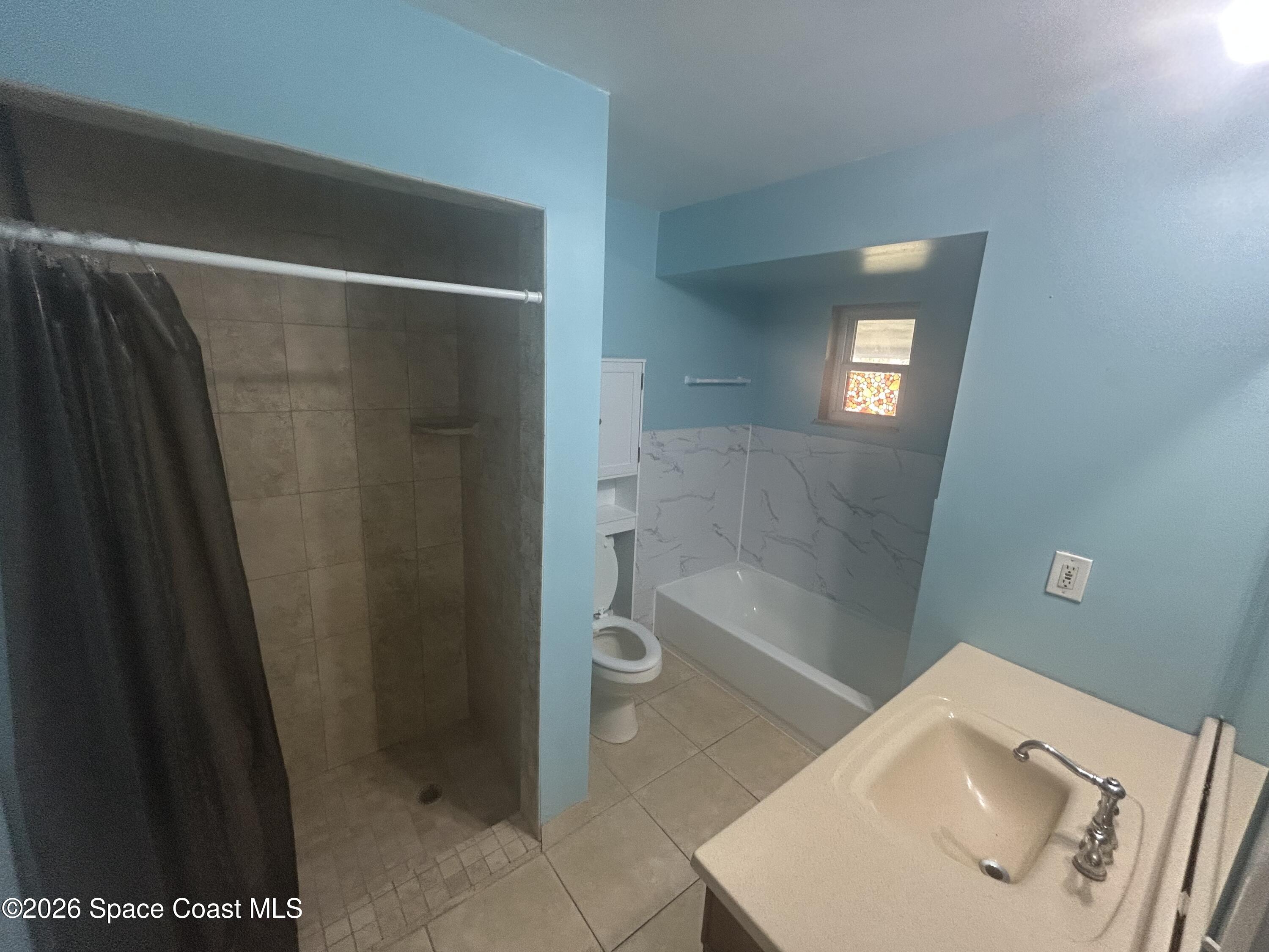 180 Richards Road Melbourne Beach, FL 32951 - Photo 12 of 32 a bathroom with a sink and a mirror