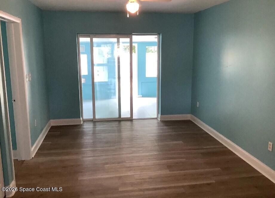 180 Richards Road Melbourne Beach, FL 32951 - Photo 17 of 32 a view of an empty room with wooden floor and a window