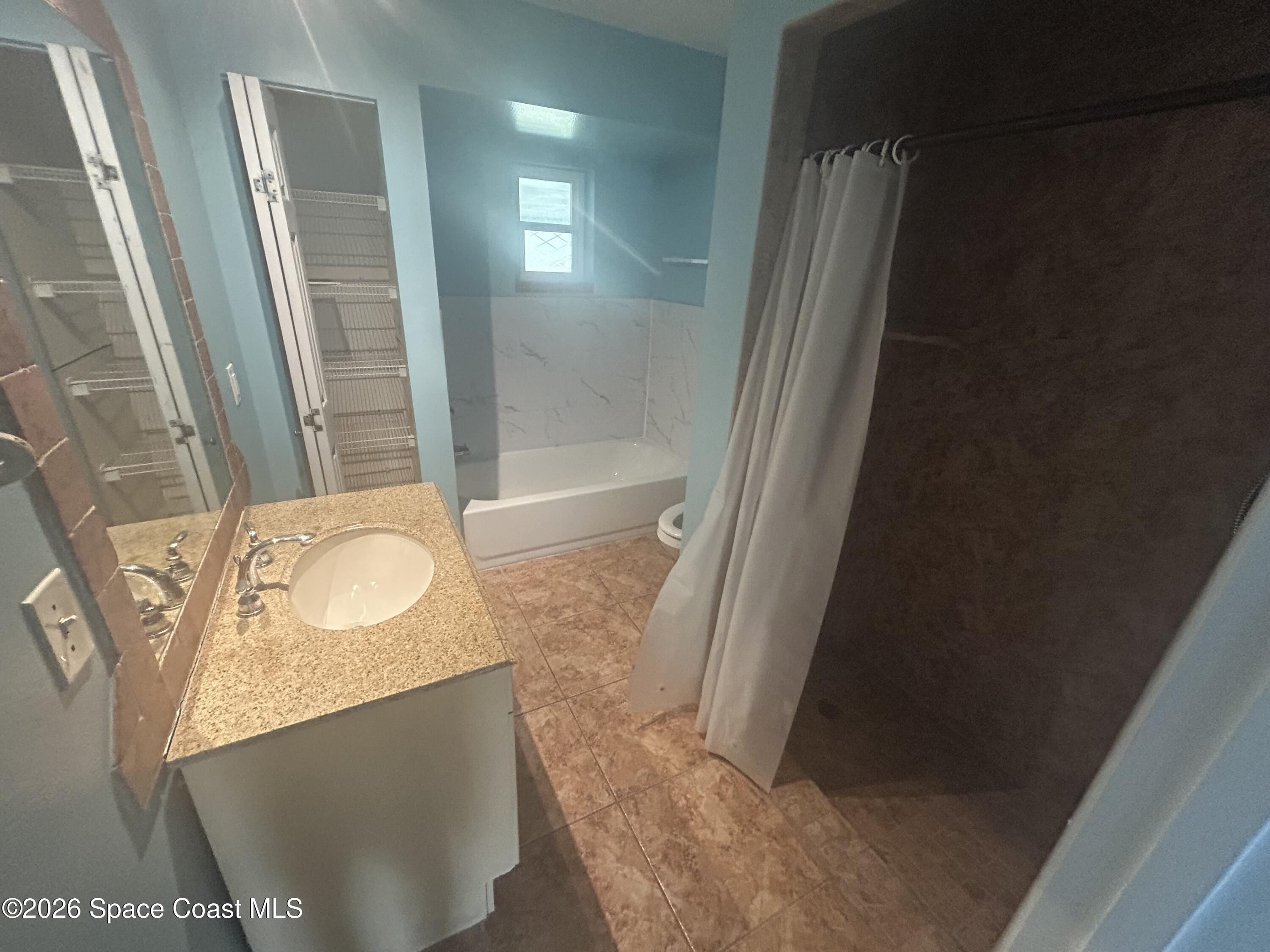 180 Richards Road Melbourne Beach, FL 32951 - Photo 20 of 32 a bathroom with a sink and a mirror