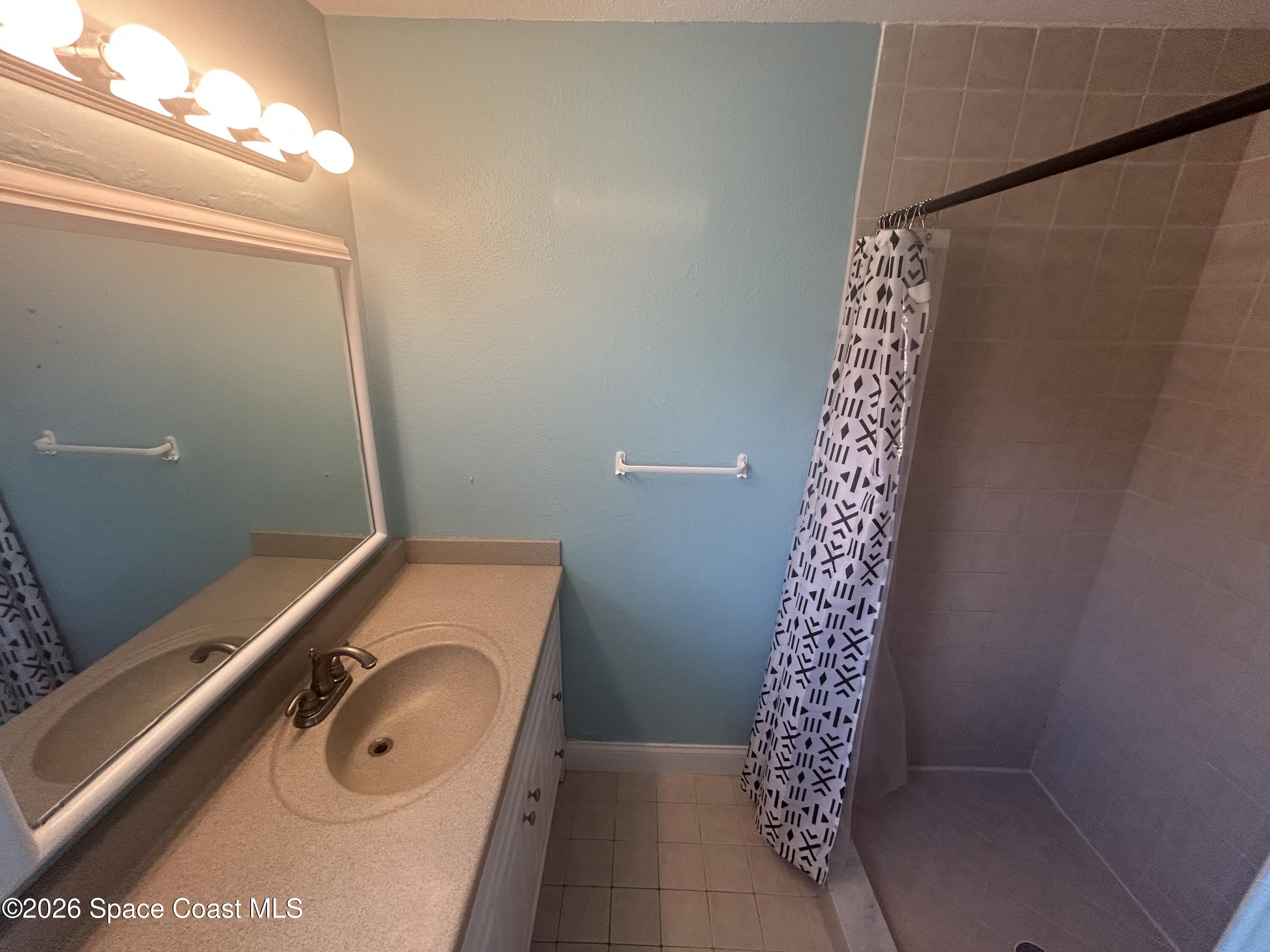 180 Richards Road Melbourne Beach, FL 32951 - Photo 25 of 32 a bathroom with a sink and a shower