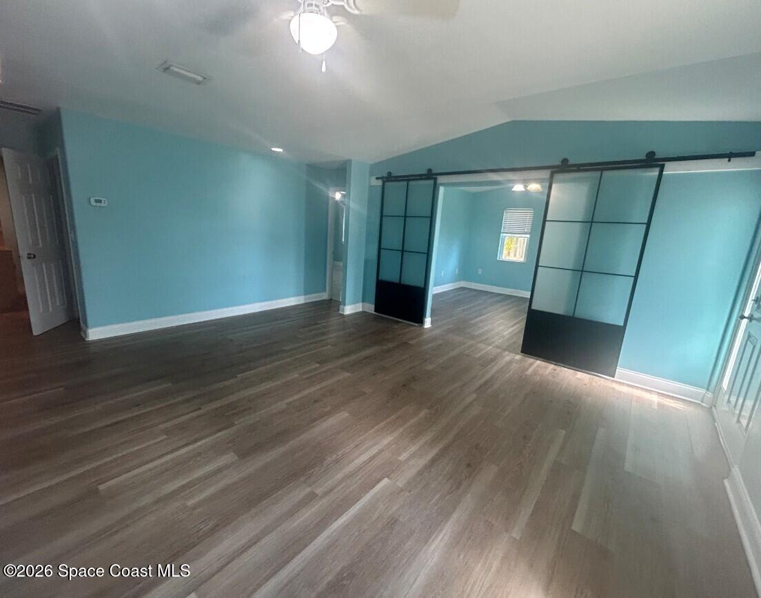 180 Richards Road Melbourne Beach, FL 32951 - Photo 6 of 32 wooden floor in an empty room with a window