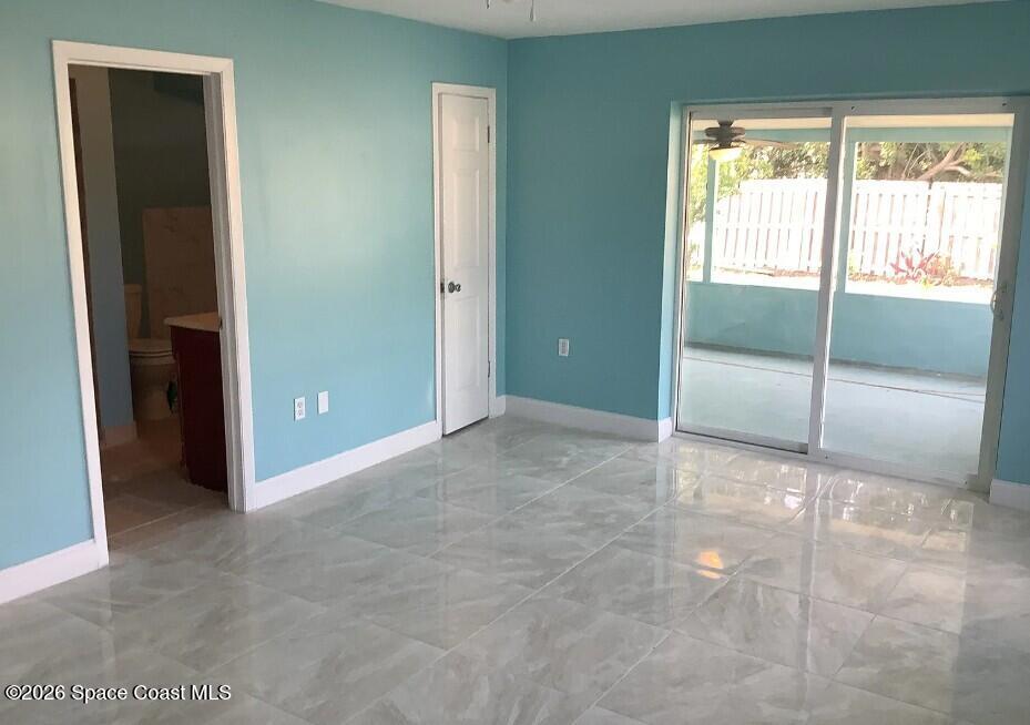 180 Richards Road Melbourne Beach, FL 32951 - Photo 9 of 32 an empty room with sliding glass door