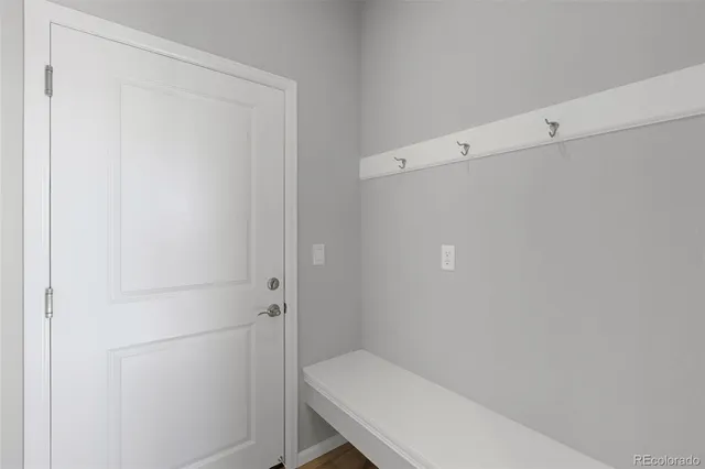 a view of a hallway with closet and wooden floor