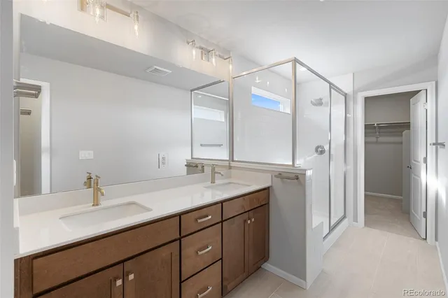 a bathroom with a sink double vanity and a mirror