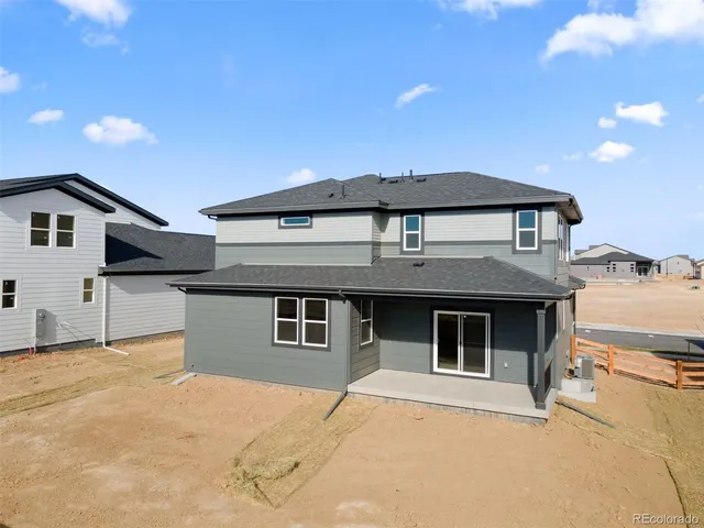 a front view of a house with a garage and a roof