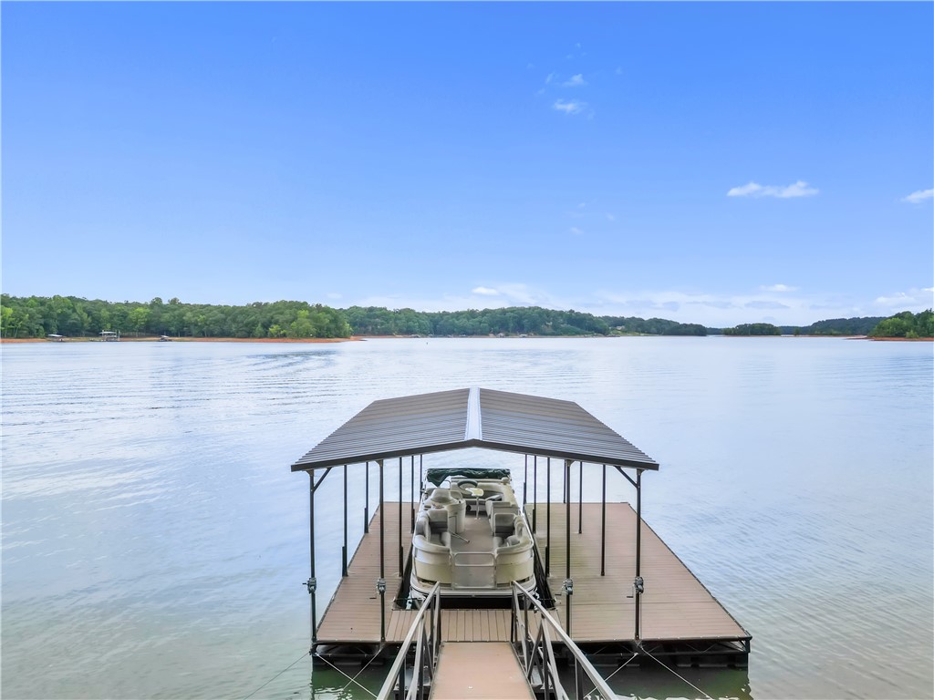 149 Inlet Pointe Drive Anderson, SC 29625 - Photo 34 of 43 A private boat dock extends over the shimmering lake, offering direct water access.
