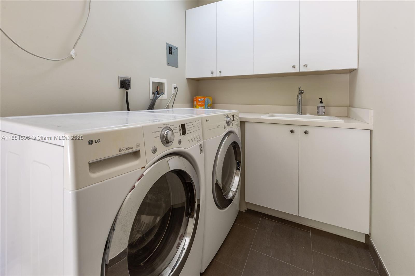 303 St Andrews Road, Unit 1968 Hollywood, FL 33021 - Photo 32 of 33 Updated, modern laundry rioom with clothesline, sink, and cabinets.