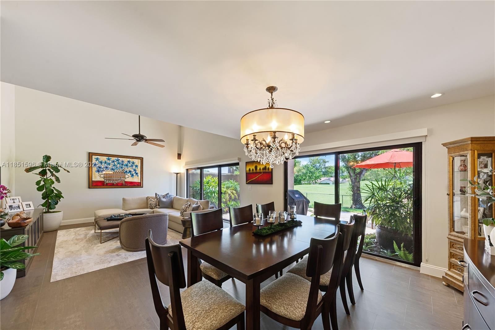 303 St Andrews Road, Unit 1968 Hollywood, FL 33021 - Photo 9 of 33 Dining area with living room and view of patio and golf course.