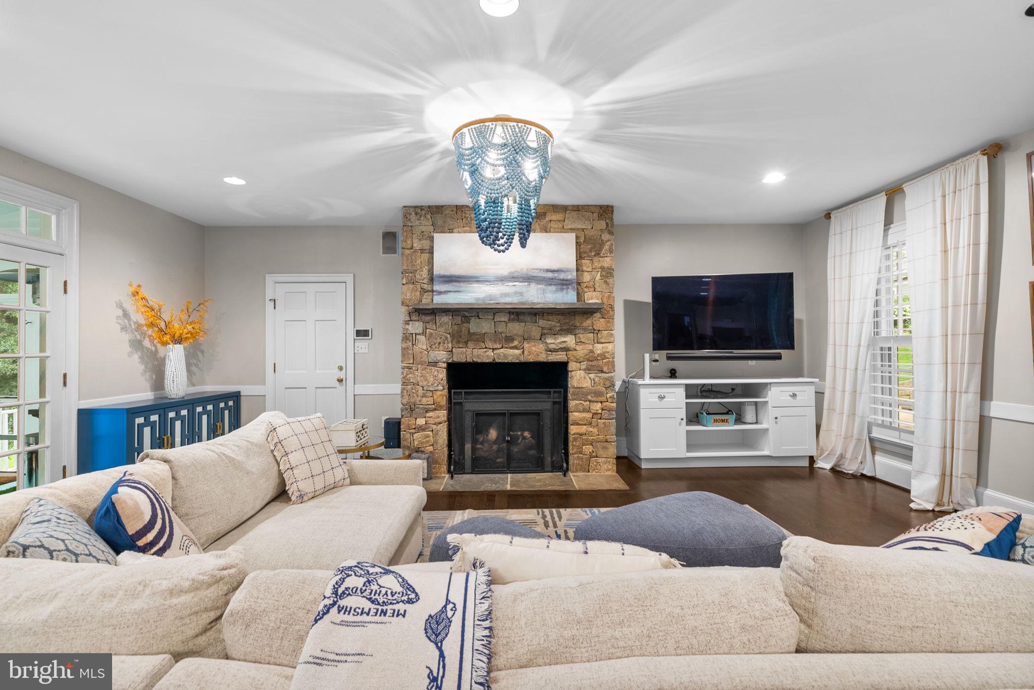 10306 Cutters Lane Potomac, MD 20854 - Photo 22 of 76 a living room with furniture a fireplace and a flat screen tv