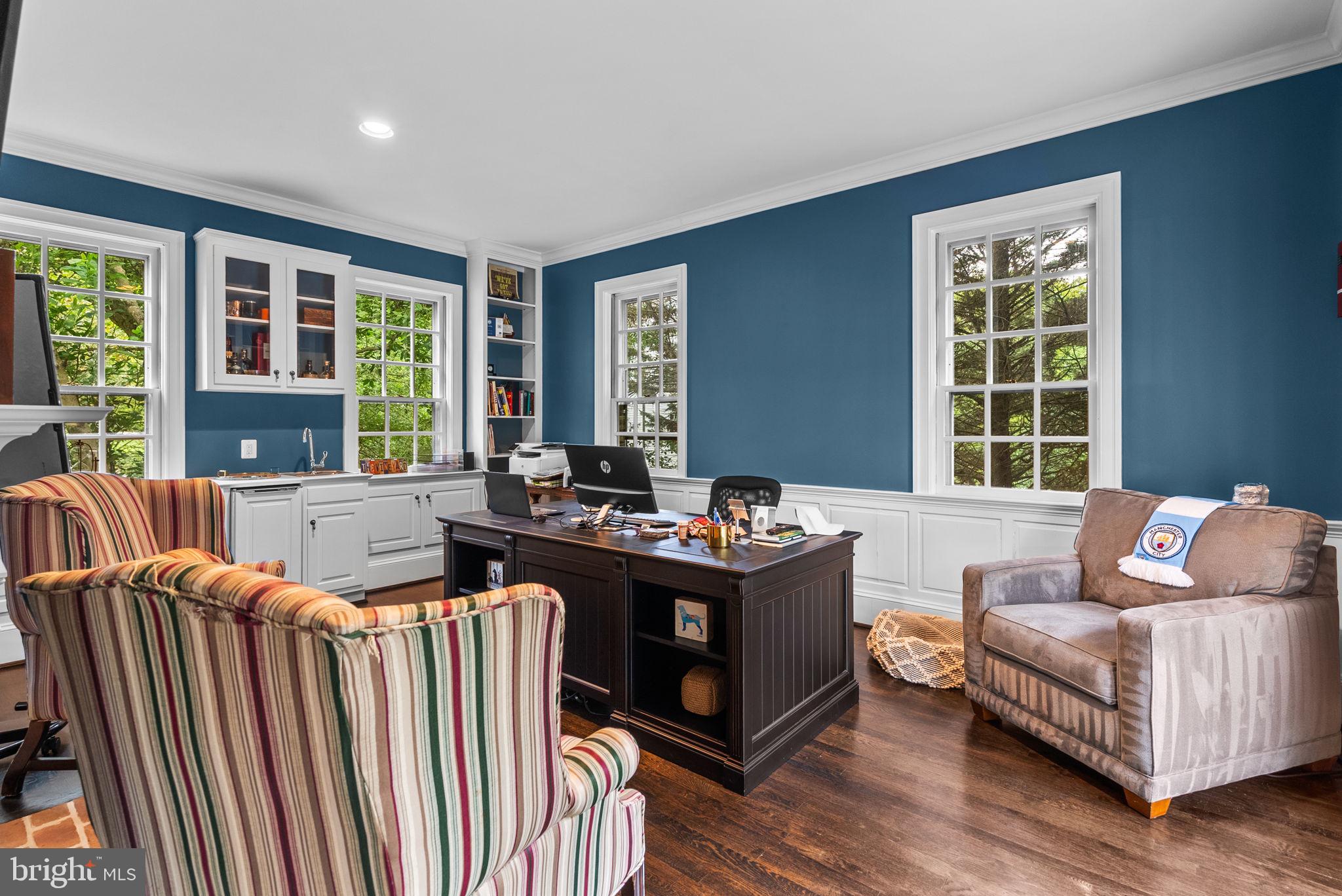 10306 Cutters Lane Potomac, MD 20854 - Photo 27 of 76 a living room with furniture fireplace and large windows