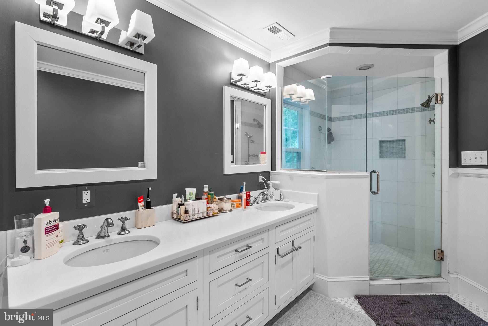 10306 Cutters Lane Potomac, MD 20854 - Photo 36 of 76 a bathroom with double vanity sink and a mirror