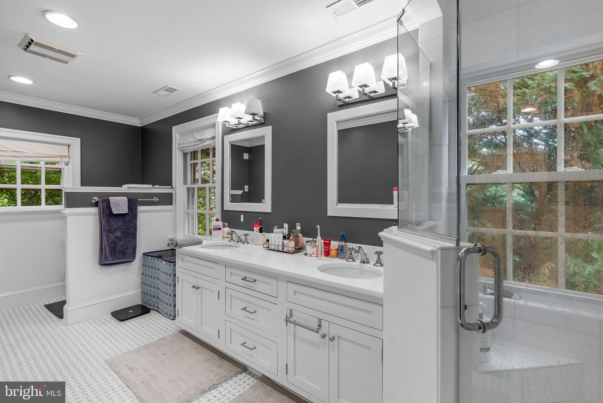 10306 Cutters Lane Potomac, MD 20854 - Photo 37 of 76 a spacious bathroom with a double vanity sink a mirror and a bathtub