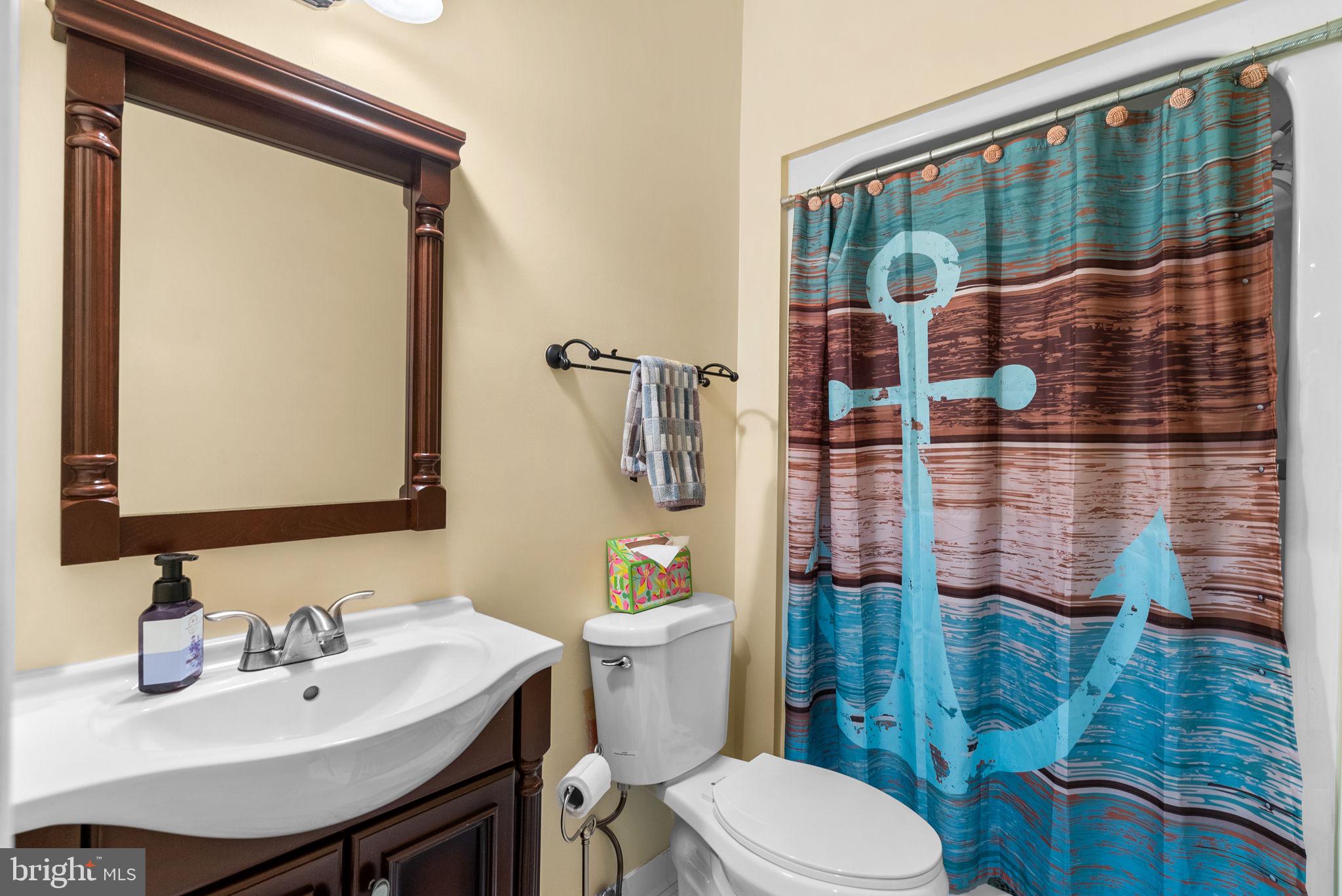 10306 Cutters Lane Potomac, MD 20854 - Photo 62 of 76 a bathroom with a sink a toilet and shower