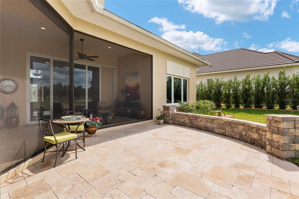 7549 Northwest 33rd Place Ocala, FL 34482 - Photo 63 of 83 a view of a patio with table and chairs and floor to ceiling window