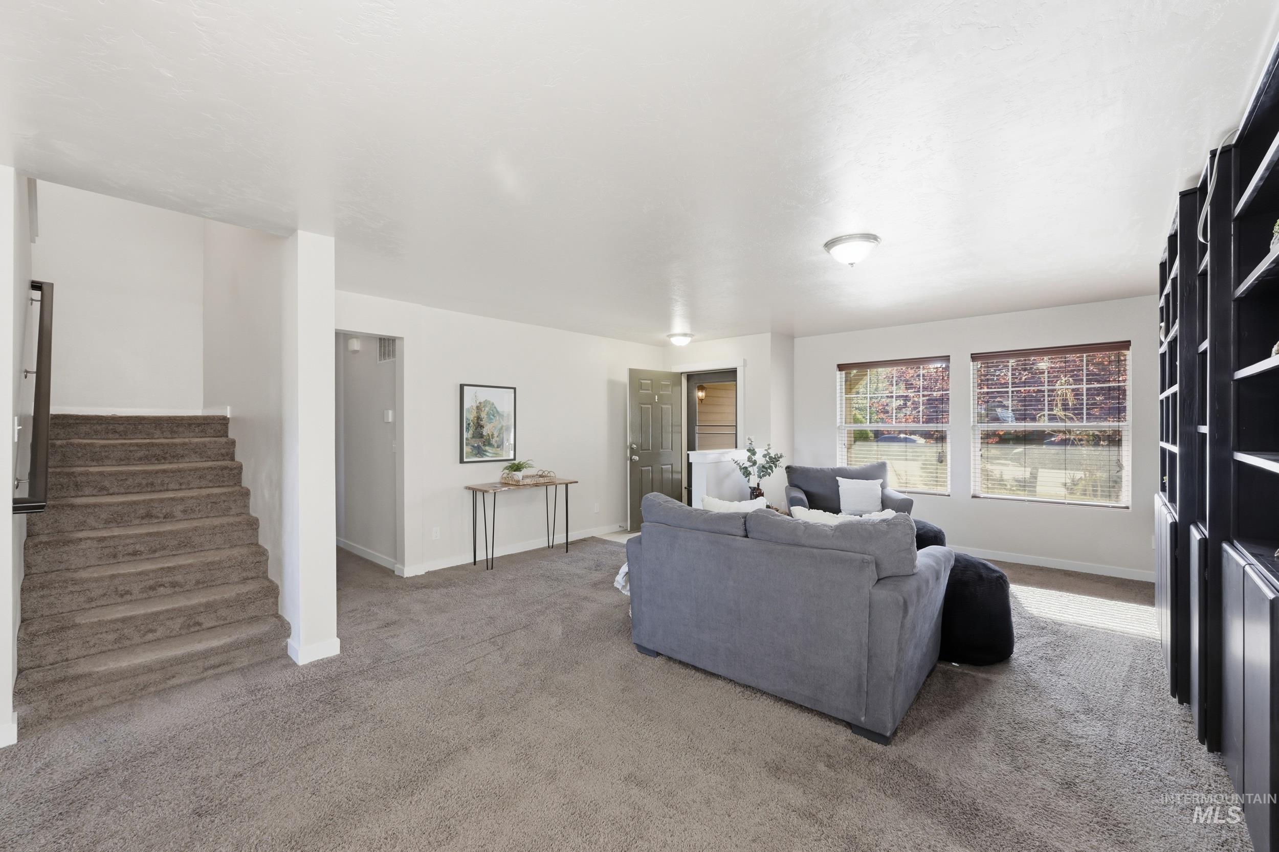 4855 South Chex Way Boise, ID 83709 - Photo 5 of 47 Carpeted living area featuring white walls, recessed lighting, and a built-in shelving unit