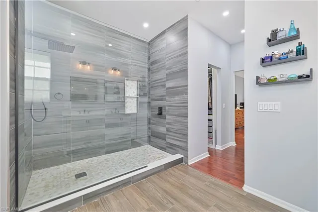a living room with furniture and floor to ceiling windows