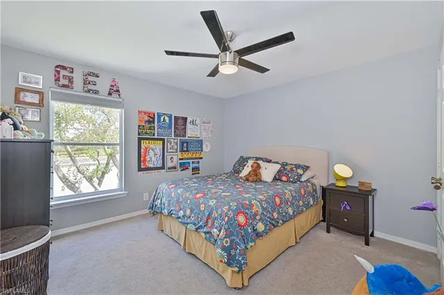 a bedroom with a bed a couch and a window