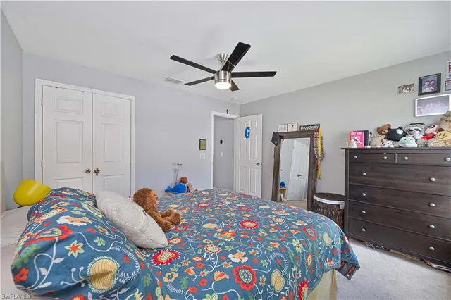 a bedroom with a bed and a dresser in it