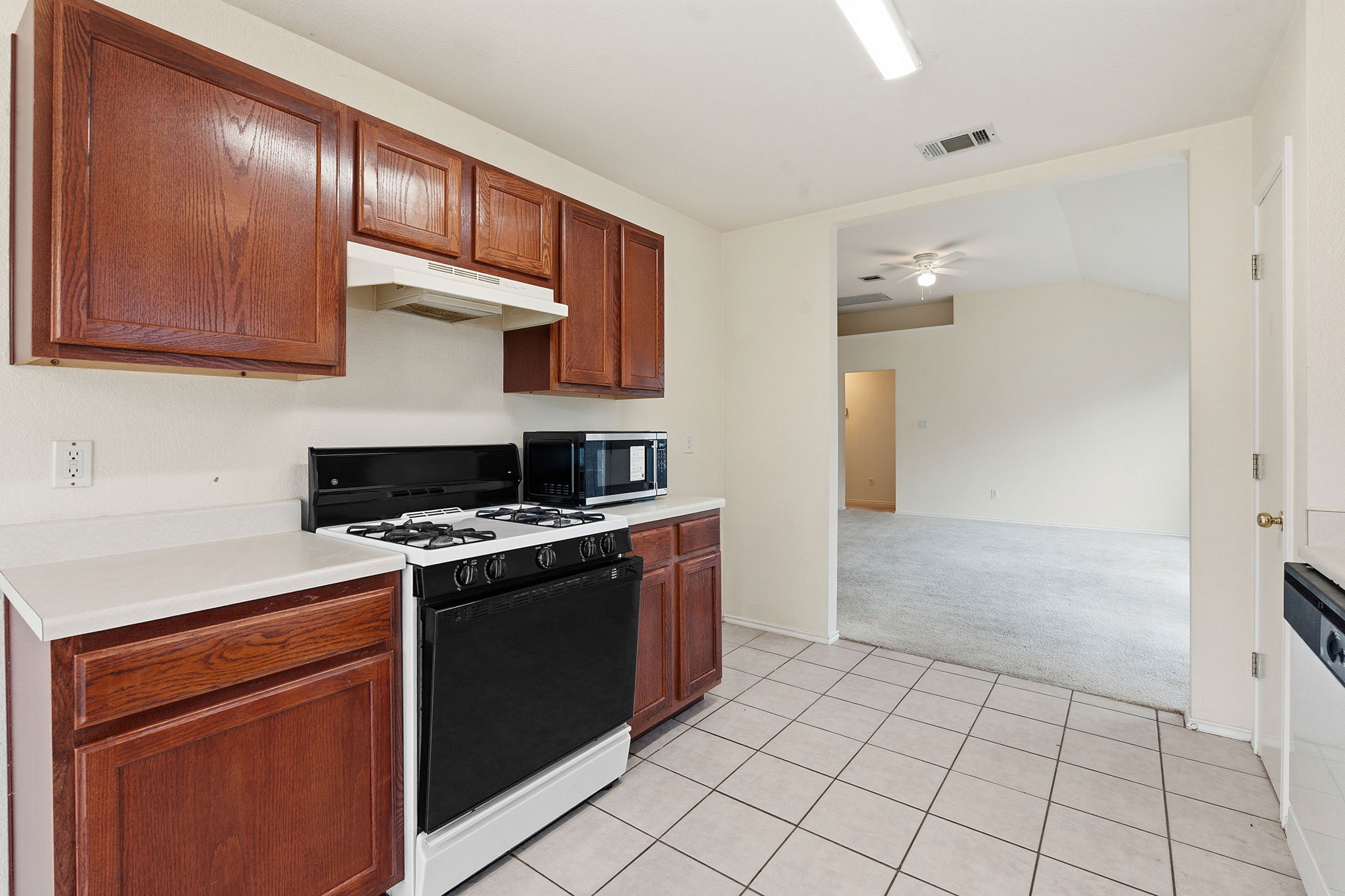 116 Blue Ridge Trail Elgin, TX 78621 - Photo 12 of 28 a kitchen with stainless steel appliances granite countertop a stove a sink and a refrigerator