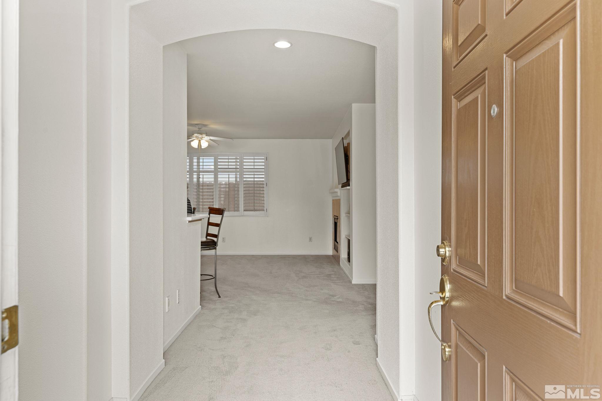 1436 Gaucho Lane Reno, NV 89521 - Photo 21 of 40 a view of a hallway with wooden shelves