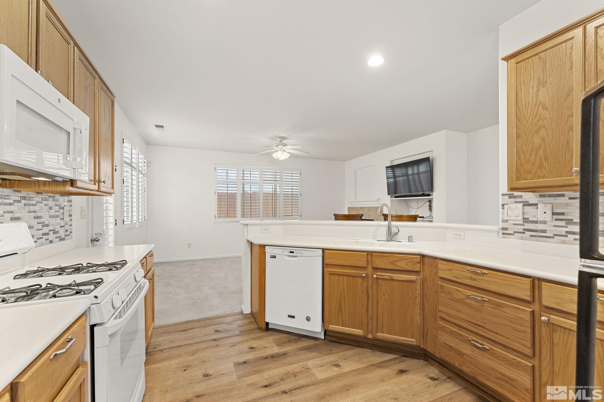 1436 Gaucho Lane Reno, NV 89521 - Photo 24 of 40 a kitchen with a sink stove and cabinets