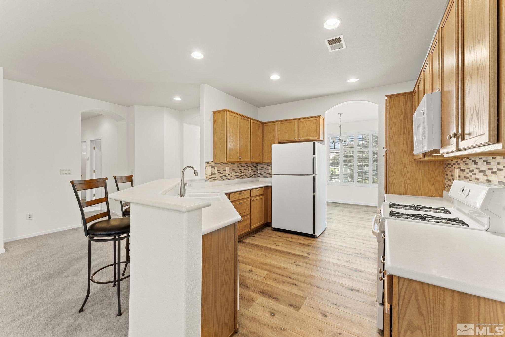 1436 Gaucho Lane Reno, NV 89521 - Photo 25 of 40 a kitchen with stainless steel appliances kitchen island granite countertop a sink and cabinets