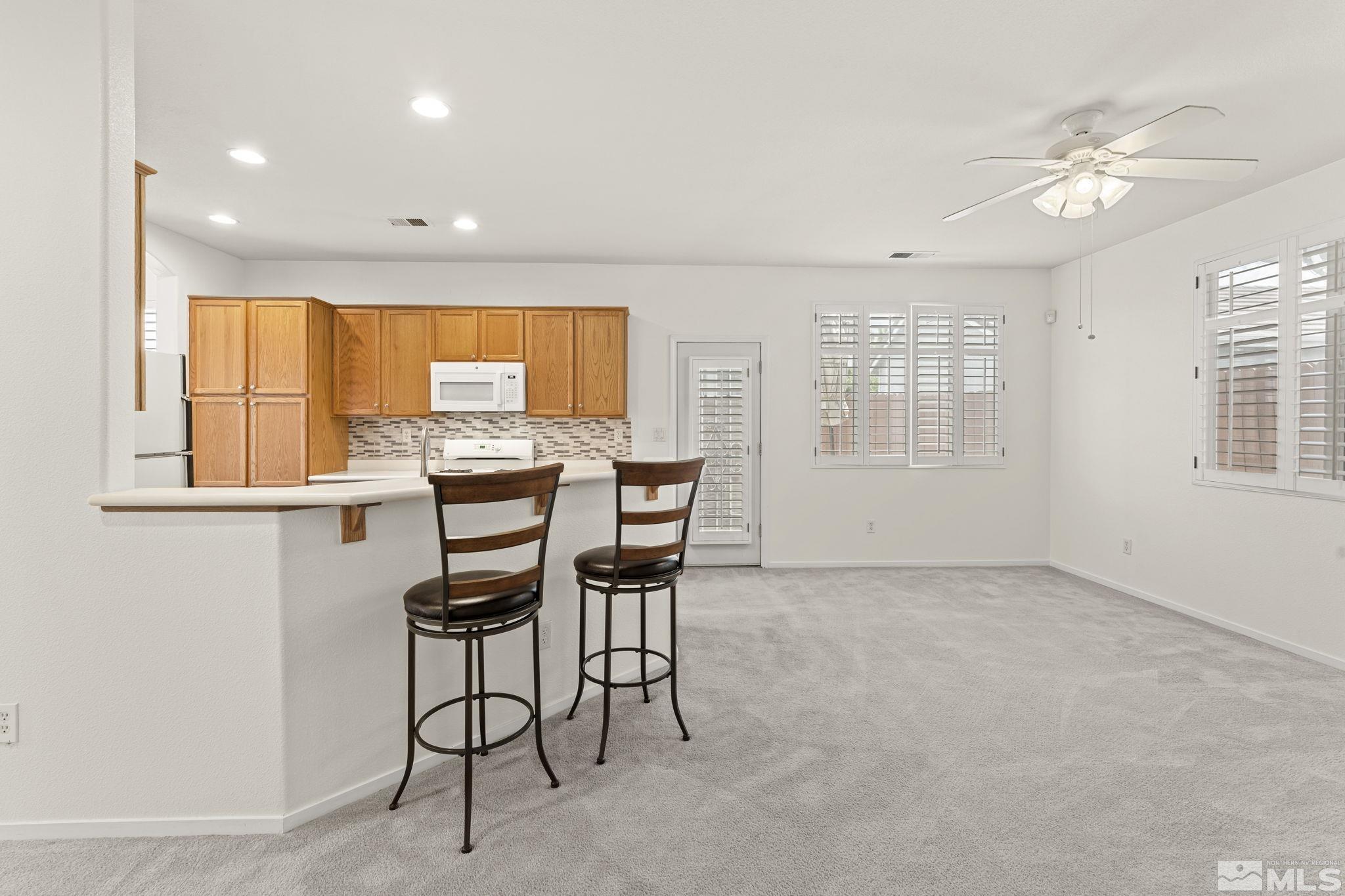 1436 Gaucho Lane Reno, NV 89521 - Photo 26 of 40 a view of a dining room with furniture window and outside view