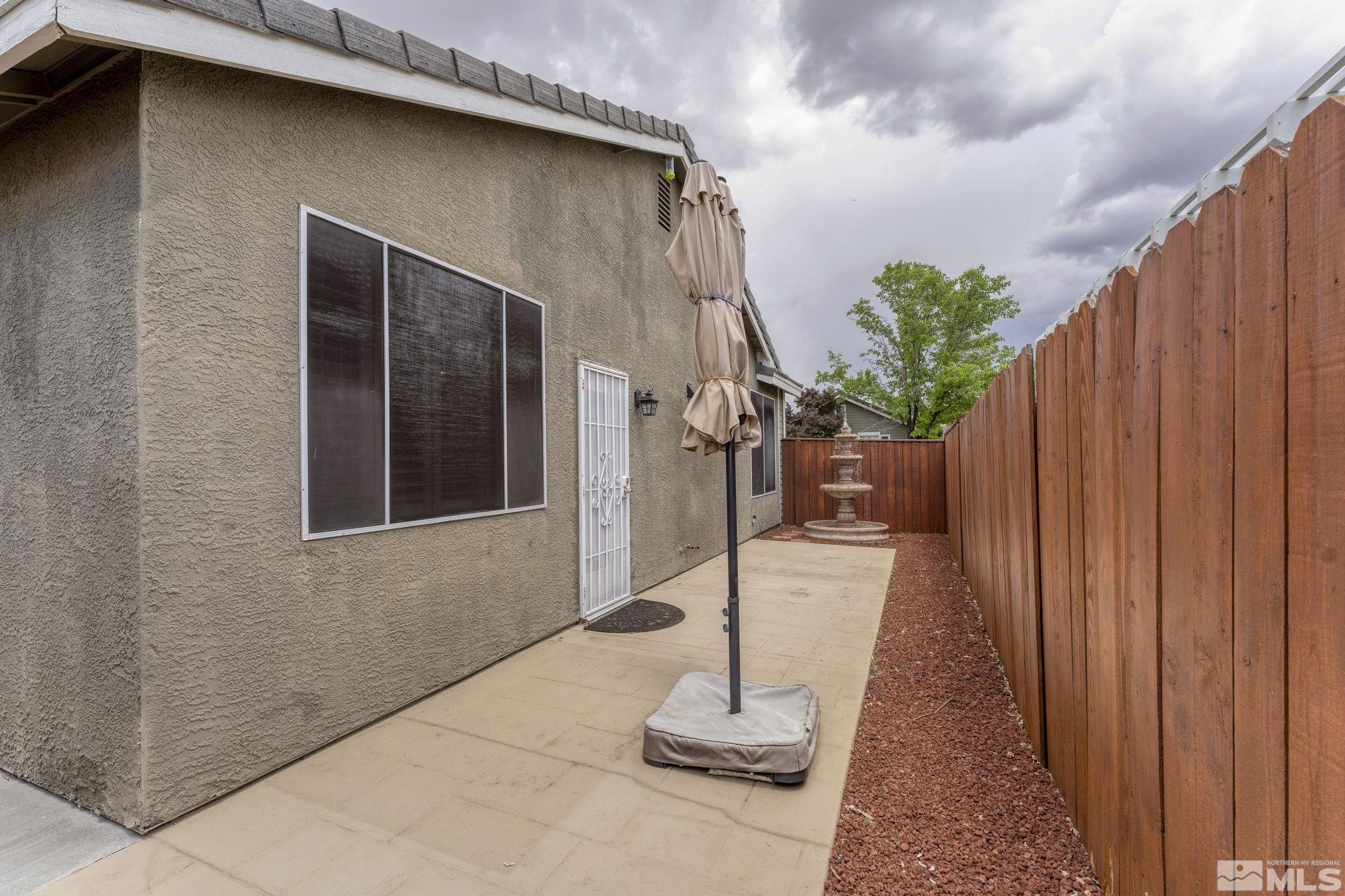 1436 Gaucho Lane Reno, NV 89521 - Photo 32 of 40 a porch with seating space and trees in the background