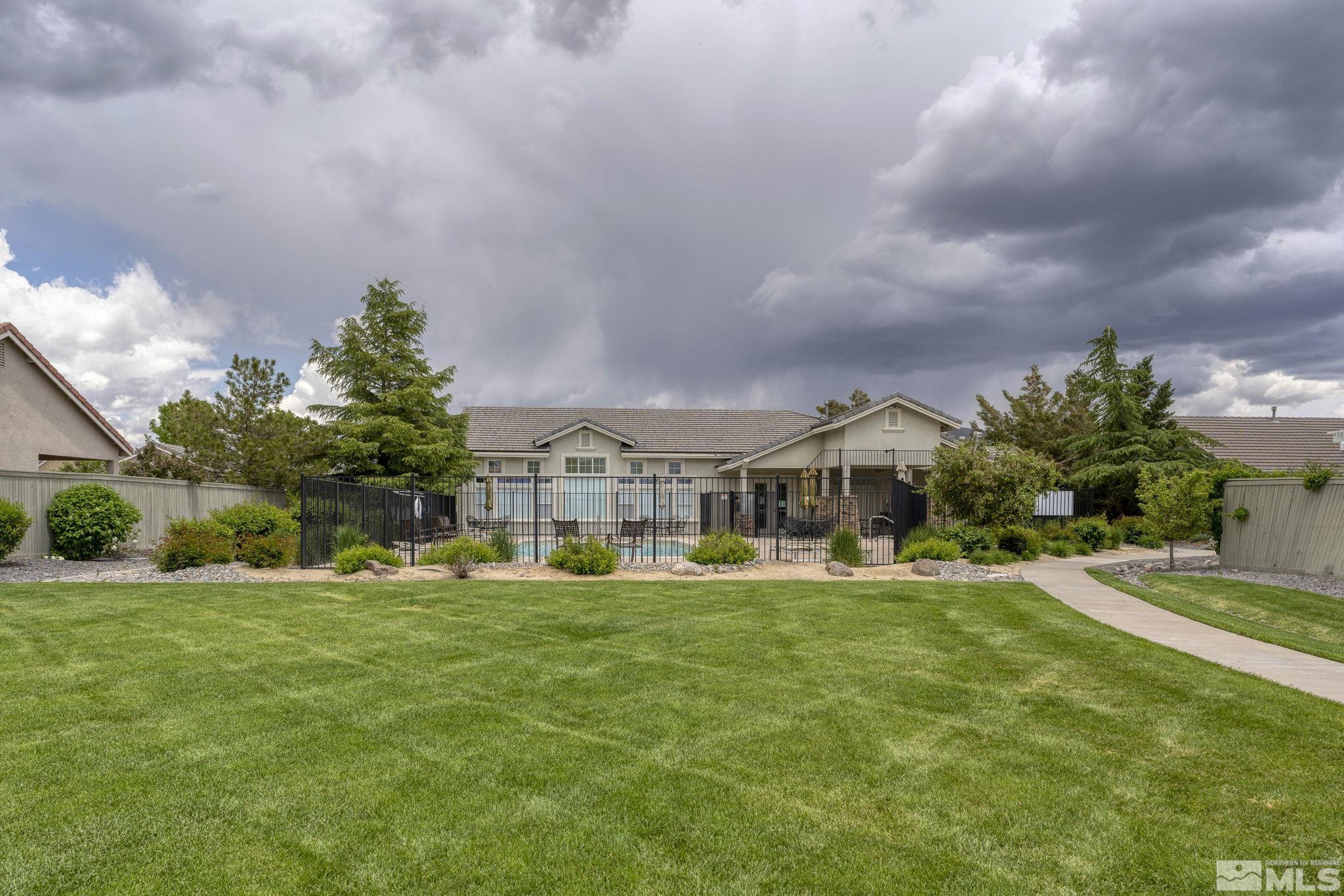 1436 Gaucho Lane Reno, NV 89521 - Photo 34 of 40 a front view of a house with a yard and trees
