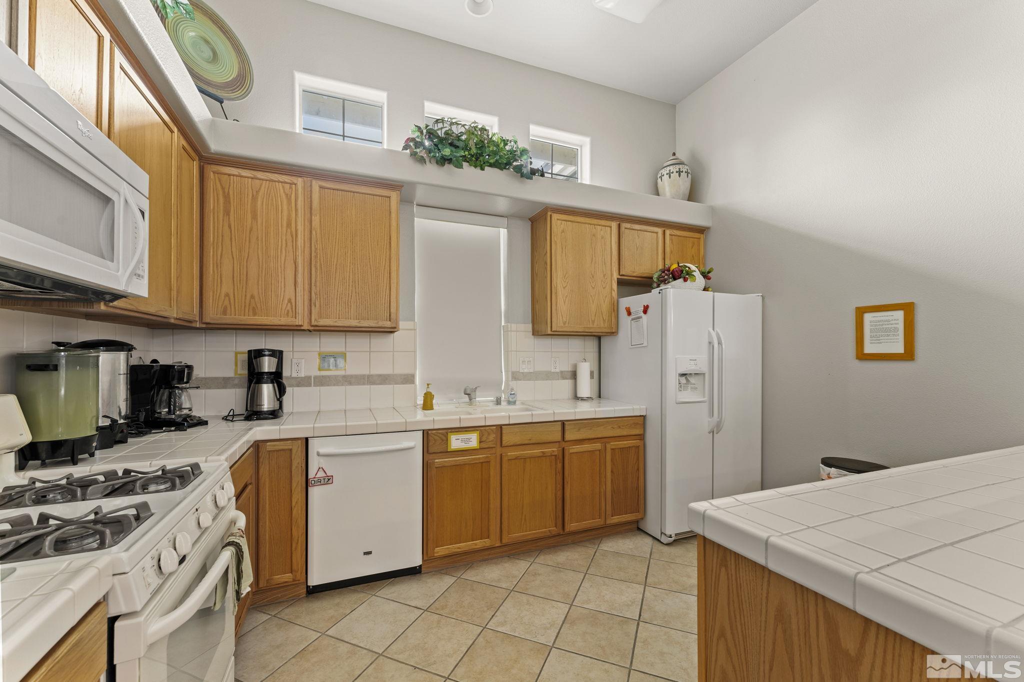 1436 Gaucho Lane Reno, NV 89521 - Photo 35 of 40 a kitchen with a sink stove and refrigerator