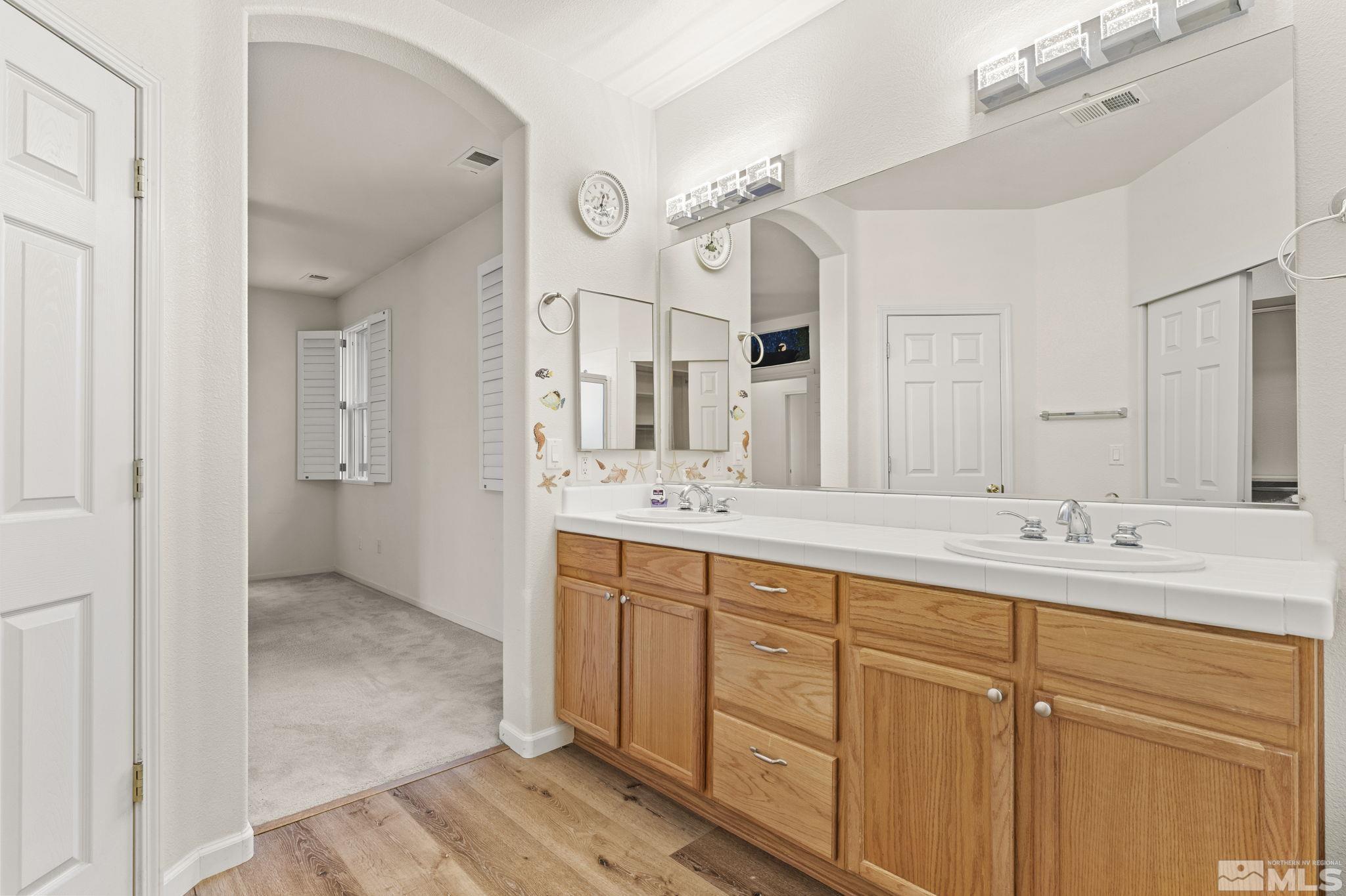 1436 Gaucho Lane Reno, NV 89521 - Photo 10 of 40 a spacious bathroom with a double vanity sink shower and a mirror