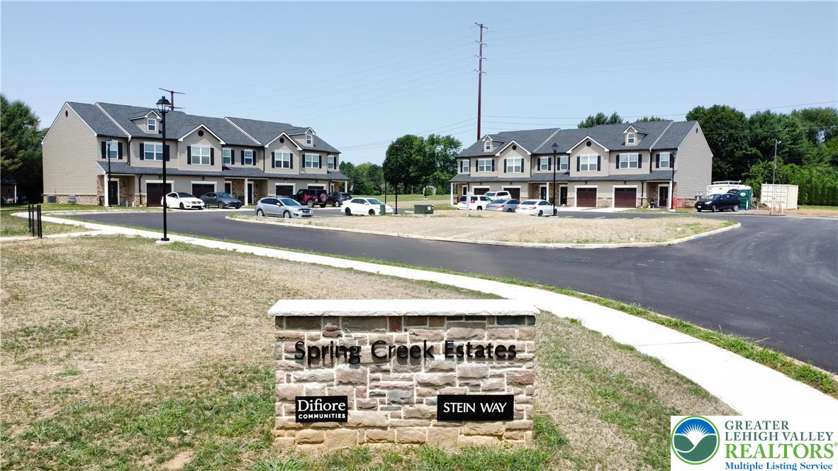 6645 Stein Way, Unit 66396661 Lower Macungie Township, PA 18062 - Photo 1 of 20 a view of a building with a yard