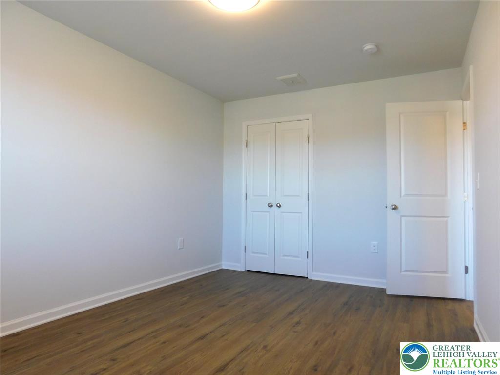 6645 Stein Way, Unit 66396661 Lower Macungie Township, PA 18062 - Photo 17 of 20 a view of an empty room and wooden floor