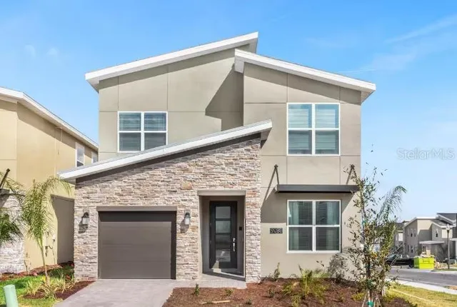 a front view of a house with a garden