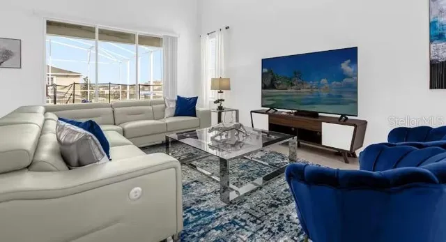 a living room with furniture and a flat screen tv