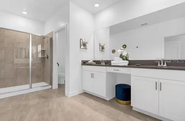 a spacious bathroom with a double vanity sink a mirror and shower