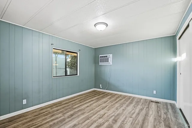 a view of a room with wooden floor and windows