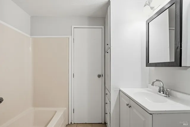 a bathroom with a sink a mirror and a bathtub