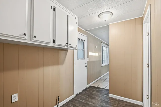 a view of a closet area with wooden floor