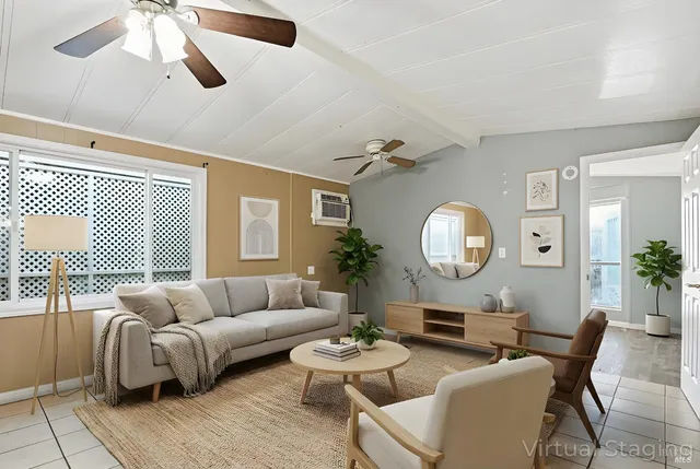 a living room with furniture a clock potted plant and a window